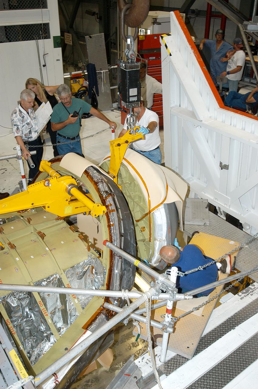 The nose cap of orbiter Endeavour is being removed for routine inspection. The nose cap is made of reinforced carbon-carbon (RCC). The RCC has an operating range of minus 250° F to about 3,000° F.