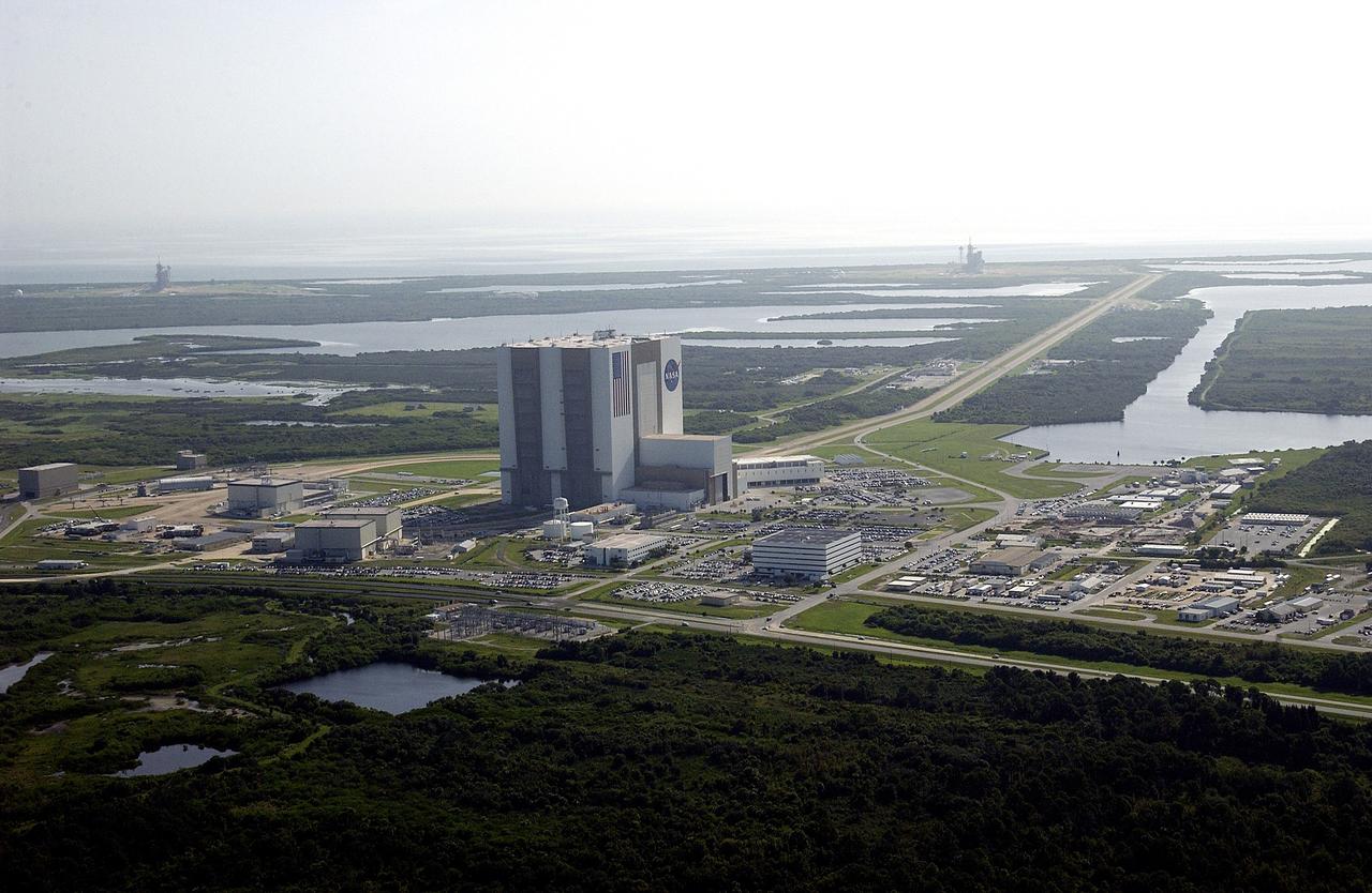 CAPE CANAVERAL, Fla. -- This aerial view shows the Launch Complex 39 Area.  At center is the 525-foot-tall Vehicle Assembly Building.  On the horizon at the far left is Launch Pad 39B to the right is Launch Pad 39A.  The crawlerway can be seen stretching from the VAB toward Pad A.  Waters of the Banana Creek and Banana River surround the pads.  At center right is the Turn Basin.    Photo credit: NASA
