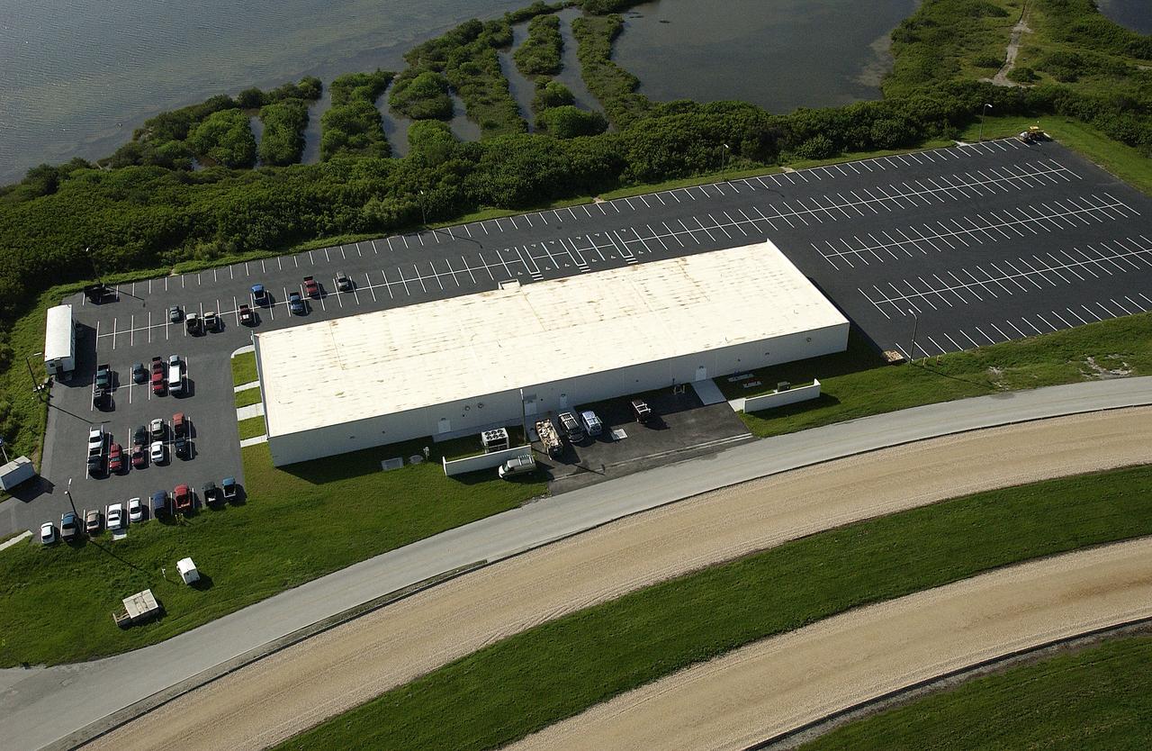 From the air, one of the new Launch Pad facilities building is seen. A mix of office and shop space, the pad facilities consolidate personnel into one site at each pad.