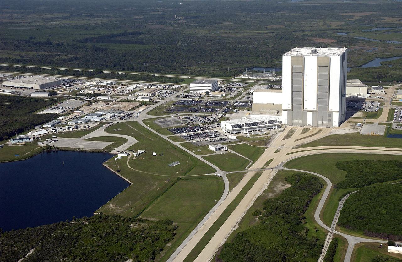 CAPE CANAVERAL, Fla. -- Looking west, this aerial view shows the crawlerway leading to the 525-foot-tall Vehicle Assembly Building. At left of the VAB is the Launch Control Center. Further to the left and west is the Operations Support Building. In the foreground at left is the Turn Basin, where external tanks are offloaded for transfer to the VAB. Photo credit: NASA