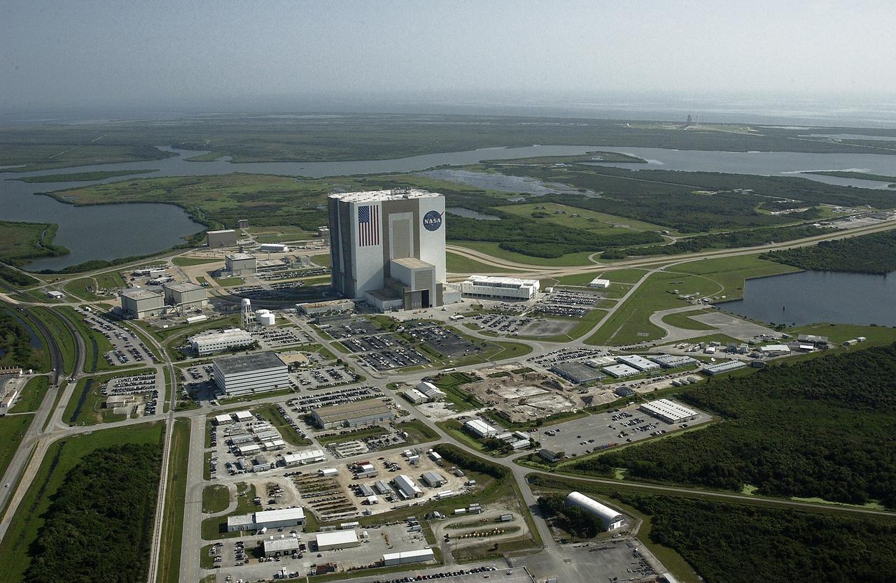 CAPE CANAVERAL, Fla. -- This view shows much of the Launch Complex 39 Area  looking north.  At center is the 525-foot-tall Vehicle Assembly Building. Other buildings surrounding it are counter clockwise from left the Orbiter Processing Facility, Multi-Function Facility, Operations Support Building and Launch Control Center, next to the VAB.  The crawlerway leads from the VAB toward the launch pads.  In the background are the waters of the Banana Creek.          Photo credit: NASA