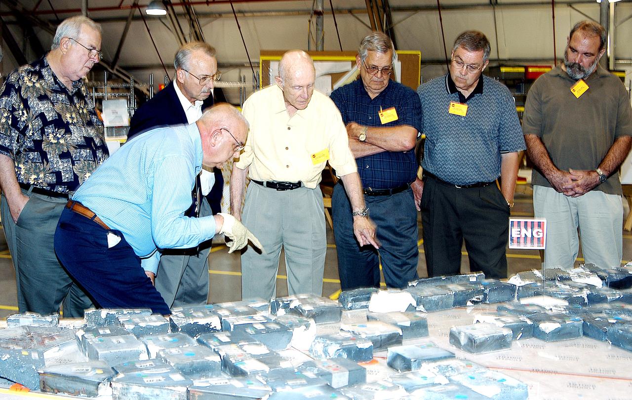 KENNEDY SPACE CENTER, FLA.  -  In the Columbia Debris Hangar, members of the  Stafford-Covey Return to Flight Task Group (SCTG) look at tiles recovered.  Chairing the task group are Richard O. Covey, former Space Shuttle commander, and Thomas P. Stafford (center), Apollo commander.  Chartered by NASA Administrator Sean O’Keefe, the task group will perform an independent assessment of NASA’s implementation of the final recommendations by the Columbia Accident Investigation Board.