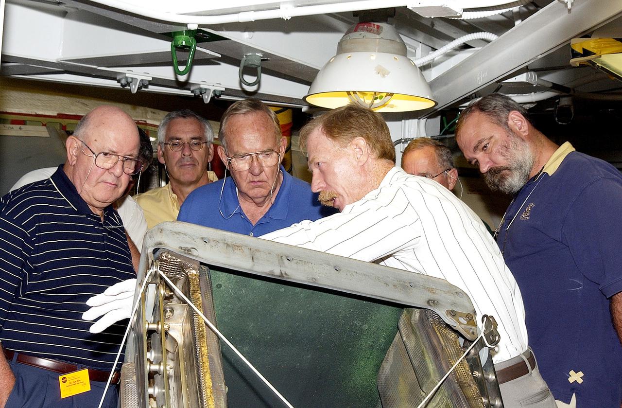 KENNEDY SPACE CENTER, FLA.  - On a tour of the Orbiter Processing Facility, members of the Stafford-Covey Return to Flight Task Group (SCTG) look at one of the Reinforced Carbon-Carbon panels, being shown by Tom Roberts with United Space Alliance, from the orbiter Endeavour.  Chairing the task group are Richard O. Covey, former Space Shuttle commander, and Thomas P. Stafford, Apollo commander.  Chartered by NASA Administrator Sean O’Keefe, the task group will perform an independent assessment of NASA’s implementation of the final recommendations by the Columbia Accident Investigation Board.