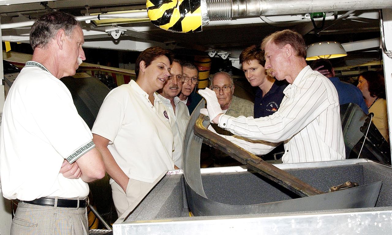 KENNEDY SPACE CENTER, FLA.  - On a tour of the Orbiter Processing Facility, members of the Stafford-Covey Return to Flight Task Group (RTFTG) look at a Reinforced Carbon-Carbon panels with a T-seal held by Tom Roberts, with United Space Alliance.  From left are Richard O. Covey, former Space Shuttle commander, Dr. Kathryn Clark, James Adamson, Joe Engle, William Wegner and Dr. Amy Donahue.  Chairing the task group are Covey and Thomas P. Stafford, Apollo commander.  Chartered by NASA Administrator Sean O’Keefe, the task group will perform an independent assessment of NASA’s implementation of the final recommendations by the Columbia Accident Investigation Board.