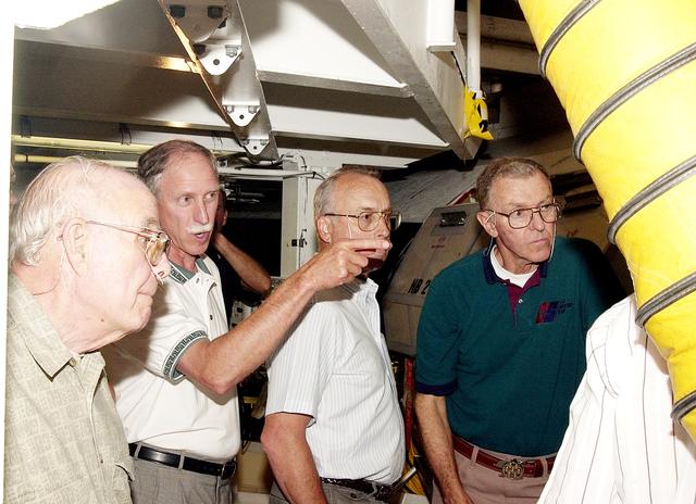 NASA image: KENNEDY SPACE CENTER, FLA.  - As the Stafford-Covey Return to Flight Task Group (SCTG) tours the Orbiter Processing Facility, Richard O. Covey (second from left), former Space Shuttle commander, points to equipment.  Covey is co-chair of the SCTG along with Thomas P. Stafford, Apollo commander. Others in the photo are William Wegner, James Adamson and Joe Engle.  Chartered by NASA Administrator Sean O’Keefe, the task group will perform an independent assessment of NASA’s implementation of the final recommendations by the Columbia Accident Investigation Board.