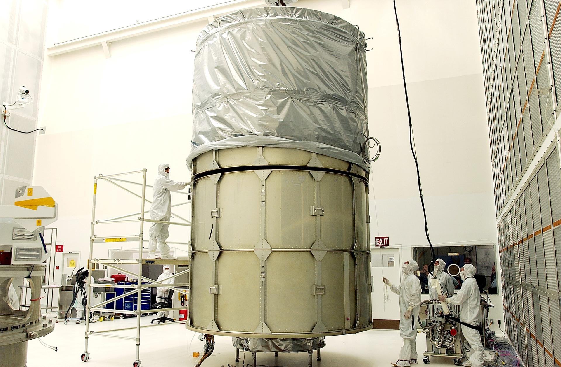 KENNEDY SPACE CENTER, FLA.  -  In Hangar A&E, Cape Canaveral Air Force Station, the upper canister is mated to the middle panels around the Space Infrared Telescope Facility (SIRTF).  The spacecraft will be transported to Launch Complex 17-B for mating with its launch vehicle, the Delta II rocket.   SIRTF consists of three cryogenically cooled science instruments and an 0.85-meter telescope, and is one of NASA's largest infrared telescopes to be launched.  SIRTF will obtain images and spectra by detecting the infrared energy, or heat, radiated by objects in space. Most of this infrared radiation is blocked by the Earth's atmosphere and cannot be observed from the ground.