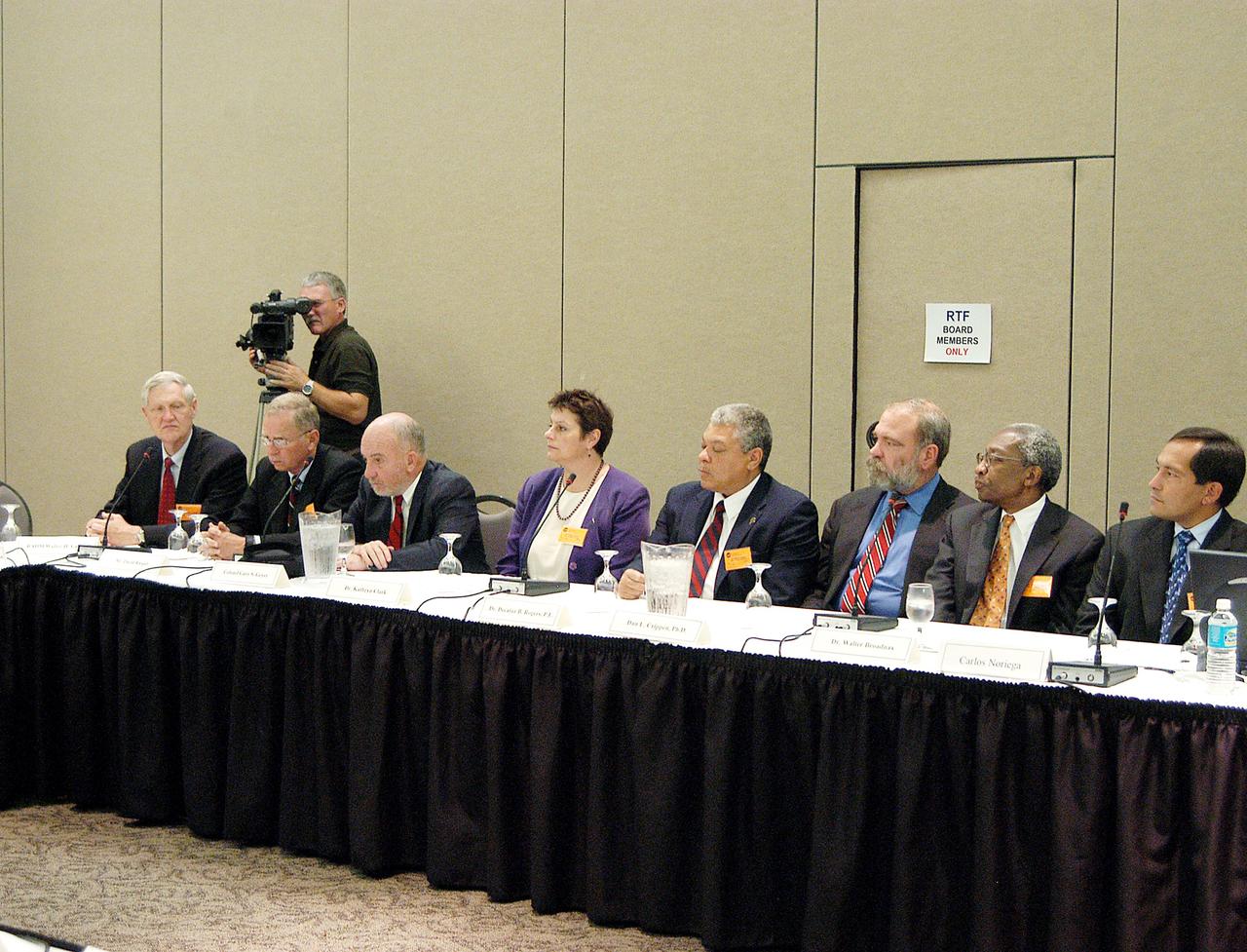 KENNEDY SPACE CENTER, FLA. - The Return To Flight Task Group (RTFTG) holds the first public meeting at the Debus Center, KSC Visitor Complex. Members and staff at the table, from left, are retired Navy Rear Adm. Walter H. Cantrell, David Raspet, retired Air Force Col. Gary S. Geyer, Dr. Kathryn Clark, Dr. Decatur B. Rogers, Dr. Dan L. Crippen, Dr. Walter Broadnax and astronaut Carlos Noriega. The RTFTG was at KSC to conduct organizational activities, tour Space Shuttle facilities and receive briefings on Shuttle-related topics. The task group was chartered by NASA Administrator Sean O’Keefe to perform an independent assessment of NASA’s implementation of the final recommendations of the Columbia Accident Investigation Board. The group is co-chaired by former Shuttle commander Richard O. Covey and retired Air Force Lt. Gen. Thomas P. Stafford, who was an Apollo commander.