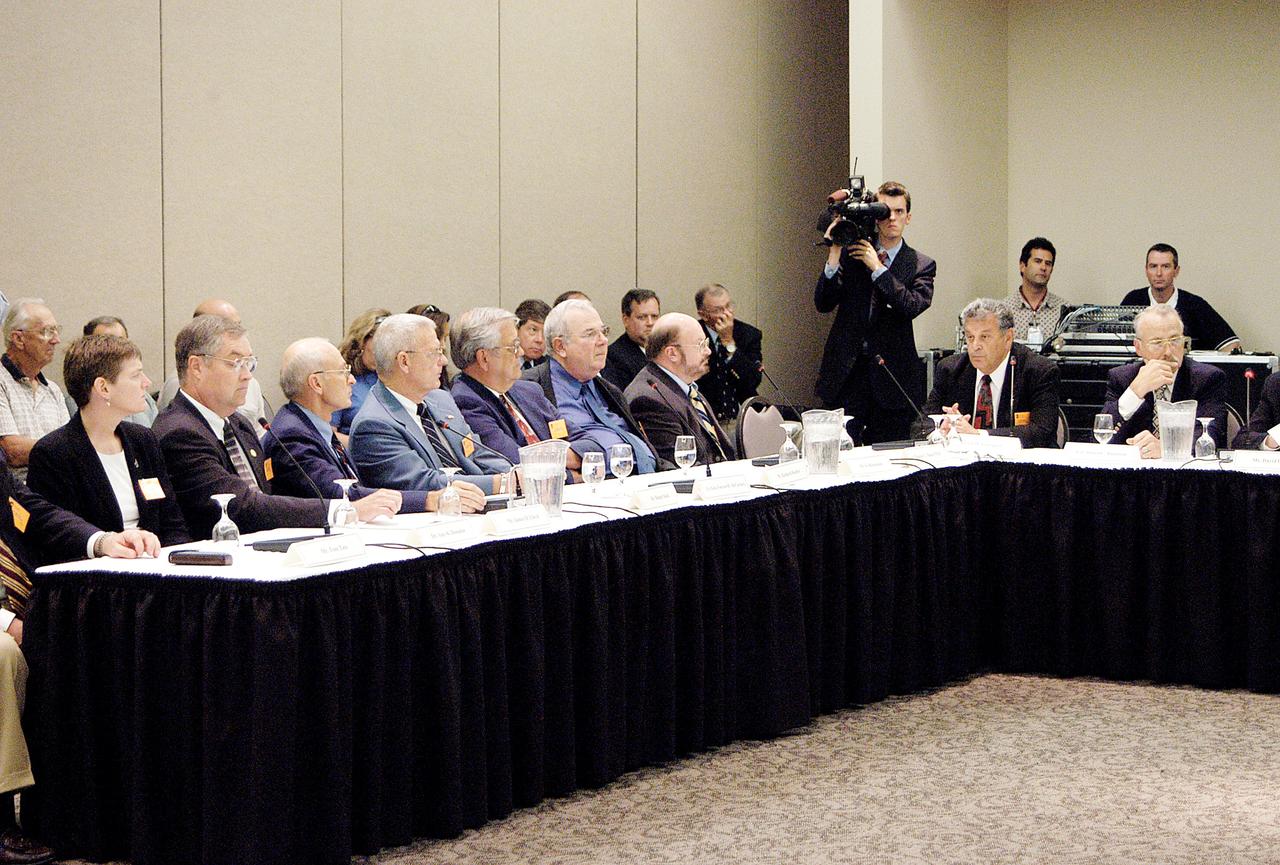 KENNEDY SPACE CENTER, FLA.  - The Return To Flight Task Group (RTFTG) holds the first public meeting at the Debus Center, KSC Visitor Complex.  Shown at the table on the left are Dr. Amy K. Donahue, James D. Lloyd, Robert Sieck, retired Air Force Lt. Gen. Forrest C. McCartney, Richard Kohrs, Sy Rubenstein and Dr. Charles C. Daniel.  The group is co-chaired by former Shuttle commander Richard O. Covey and retired Air Force Lt. Gen. Thomas P. Stafford, who was an Apollo commander.   The RTFTG was at KSC to conduct organizational activities, tour Space Shuttle facilities and receive briefings on Shuttle-related topics.  The task group was chartered by NASA Administrator Sean O’Keefe to perform an independent assessment of NASA’s implementation of the final recommendations of the Columbia Accident Investigation Board.