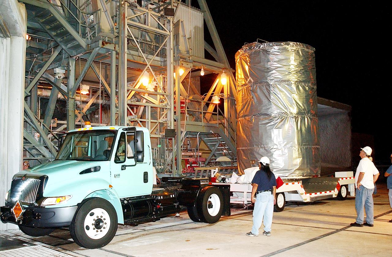 KENNEDY SPACE CENTER, FLA.  -  Before dawn, the Space Infrared Telescope Facility (SIRTF) arrives at Launch Pad 17-B, Cape Canaveral Air Force Station, where it will be lifted into the mobile service tower and prepared for launch.  SIRTF consists of three cryogenically cooled science instruments and an 0.85-meter telescope, and is one of NASA’s largest infrared telescopes to be launched.  It is the fourth and final element in NASA’s family of orbiting “Great Observatories.”  SIRTF will obtain images and spectra by detecting the infrared energy, or heat, radiated by objects in space. Most of this infrared radiation is blocked by the Earth's atmosphere and cannot be observed from the ground.