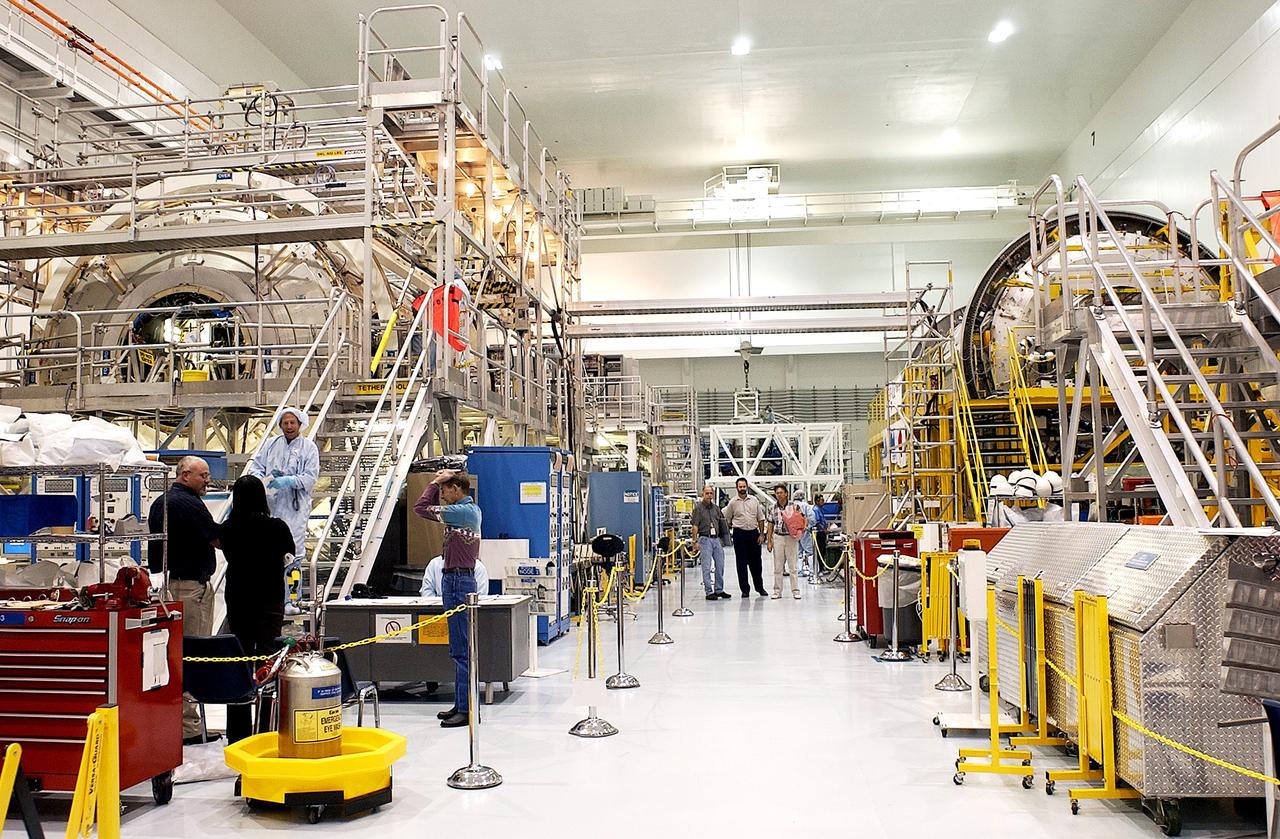 KENNEDY SPACE CENTER, FLA.  - In the Space Station Processing Facility can be seen the U.S. Node 2 (at left) and the Japanese Experiment Module (JEM)’s Pressurized Module (at right).  The  Italian-built Node 2, the second of three Space Station connecting modules, attaches to the end of the U.S. Lab and will provide attach locations for the Japanese laboratory, European laboratory, the Centrifuge Accommodation Module and, later, Multipurpose Logistics Modules. It will provide the primary docking location for the Shuttle when a pressurized mating adapter is attached to Node 2.  Installation of the module will complete the U.S. Core of the ISS.  Node 2 is the designated payload for mission STS-120.  No orbiter or launch date has been determined yet.  The Pressurized Module is the first element of the JEM to be delivered to KSC. The JEM is Japan's primary contribution to the Station. It will enhance the unique research capabilities of the orbiting complex by providing an additional environment for astronauts to conduct science experiments.  The JEM also includes an exposed facility (platform) for space environment experiments, a robotic manipulator system, and two logistics modules. The various JEM components will be  assembled in space over the course of three Shuttle missions.
