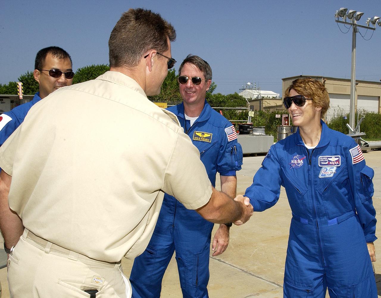 KENNEDY SPACE CENTER, FLA. -  Members of the STS-114 crew are welcomed to the Liberty Star, one of two SRB Retrieval Ships, by Captain Bren Wade (back to camera).  Crew members, from left, are Mission Specialist Soichi Noguchi, Mission Specialist Stephen Robinson and Commander Eileen Collins. Noguchi is with the Japanese space agency NASDA. Not pictured is Pilot James Kelly.  On their mission, the crew will carry the MultiPurpose Logistics Module (MPLM) Raffaello and External Stowage Platform 2 to the International Space Station.  The MPLM will contain supplies and equipment.  Another goal of the mission is to remove and replace a Control Moment Gyro.  Launch date for mission STS-114 is under review.