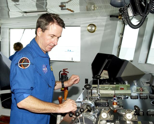 NASA image: KENNEDY SPACE CENTER, FLA. -  On a tour of the Liberty Star, one of two SRB Retrieval Ships, STS-114 Mission Specialist Stephen Robinson looks over controls.  Other crew members are Mission Specialist Soichi Noguchi, Commander Eileen Collins and Pilot James Kelly.   Noguchi is with the Japanese space agency NASDA.  On their mission, the crew will carry the MultiPurpose Logistics Module (MPLM) Raffaello and External Stowage Platform 2 to the International Space Station.  The MPLM will contain supplies and equipment.  Another goal of the mission is to remove and replace a Control Moment Gyro.  Launch date for mission STS-114 is under review.