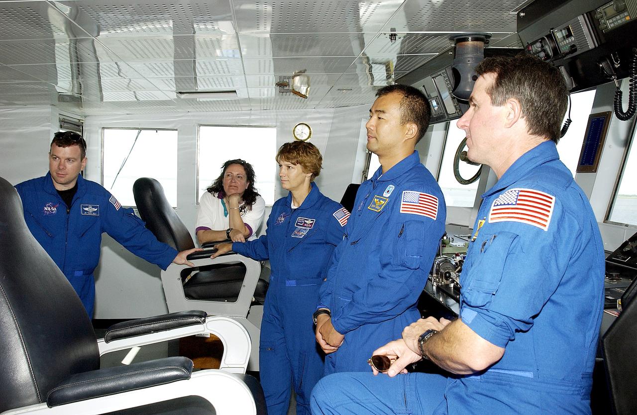 KENNEDY SPACE CENTER, FLA. -  The STS-114 crew visit the bridge of the Liberty Star, one of two SRB Retrieval Ships.  From left are Pilot James Kelly, Louise Kleba (with the Vehicle Integration Test Team (VITT) office), Commander Eileen Collins and Mission Specialists Soichi Noguchi and Stephen Robinson. Noguchi is with the Japanese space agency NASDA. On their mission, the crew will carry the MultiPurpose Logistics Module (MPLM) Raffaello and External Stowage Platform 2 to the International Space Station.  The MPLM will contain supplies and equipment.  Another goal of the mission is to remove and replace a Control Moment Gyro.  Launch date for mission STS-114 is under review.