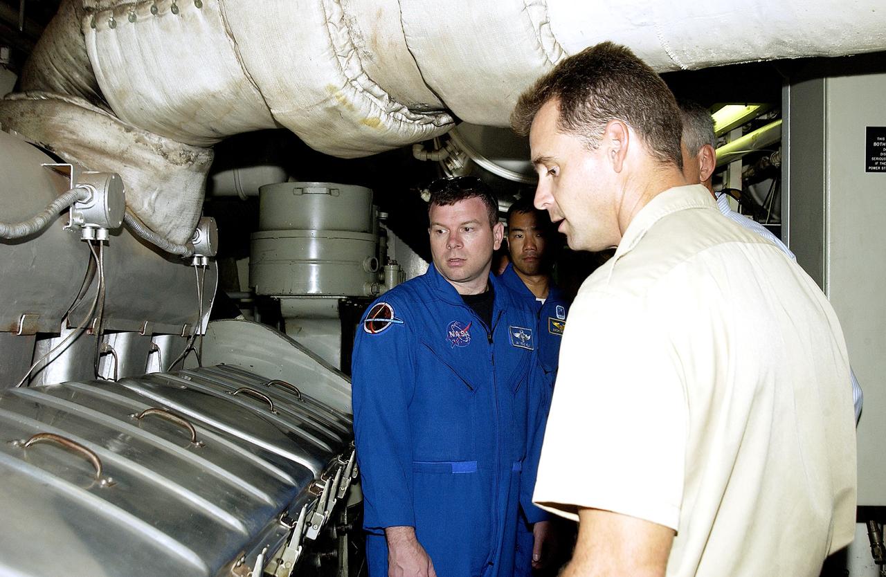 KENNEDY SPACE CENTER, FLA. -   Captain Bren Wade of the Liberty Star, one of two SRB Retrieval Ships, talks to STS-114 crew members about the engines.  Seen at left are Pilot James Kelly and Mission Specialist Soichi Noguchi, who is with the Japanese space agency NASDA..   On their mission, the crew  - which includes Commander Eileen Collins and Mission Specialist Stephen Robinson - will carry the MultiPurpose Logistics Module (MPLM) Raffaello and External Stowage Platform 2 to the International Space Station.  The MPLM will contain supplies and equipment.  Another goal of the mission is to remove and replace a Control Moment Gyro.  Launch date for mission STS-114 is under review.