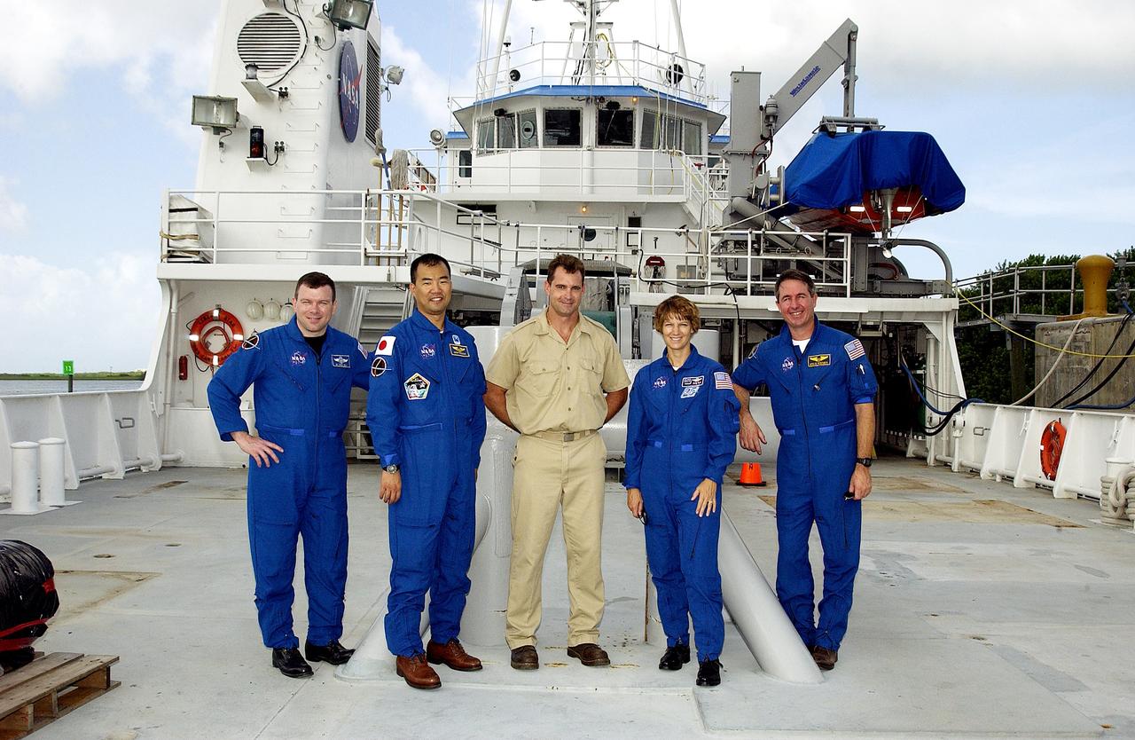 KENNEDY SPACE CENTER, FLA. -   The STS-114 crew poses on deck with the captain of the Liberty Star, one of the SRB Retrieval Ships docked at Hangar AF on the Banana River.   From left are Pilot James Kelly, Mission Specialist Soichi Noguchi, Capt. Bren Wade, Commander Eileen Collins and Mission Specialist Stephen Robinson.  Noguchi is with the Japanese space agency NASDA.  Mission STS-114 will carry the MultiPurpose Logistics Module (MPLM) Raffaello and External Stowage Platform 2 to the International Space Station.  The MPLM will contain supplies and equipment.  Another goal of the mission is to remove and replace a Control Moment Gyro.  Launch date for mission STS-114 is under review.