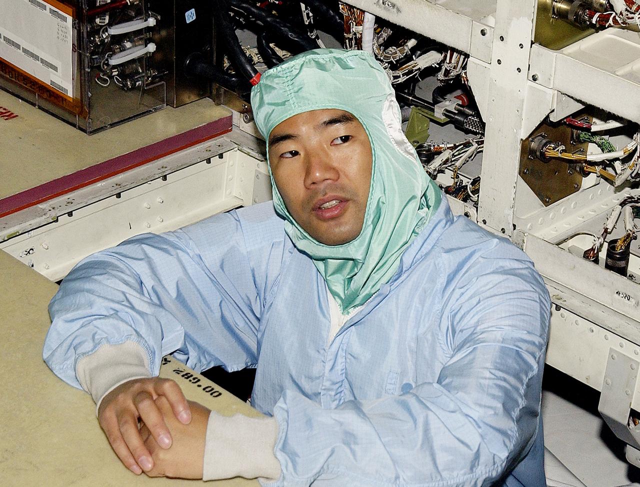 KENNEDY SPACE CENTER, FLA. -   STS-114 Mission Specialist Soichi Noguchi checks the midbody of orbiter Atlantis.  He and other crew members -  Commander Eileen Collins, Pilot James Kelly and Mission Specialist Stephen Robinson - are at KSC for equipment familiarization.  Noguchi is with the Japanese space agency NASDA.  Mission STS-114 will carry the MultiPurpose Logistics Module (MPLM) Raffaello and External Stowage Platform 2 to the International Space Station.  The MPLM will contain supplies and equipment.  Another goal of the mission is to remove and replace a Control Moment Gyro.  Launch date for mission STS-114 is under review.
