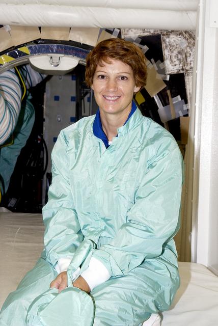 NASA image: KENNEDY SPACE CENTER, FLA. -  STS-114 Commander Eileen Collins sits in the entry hatch to orbiter Atlantis.  She and other crew members - Pilot James Kelly and  Mission Specialists Soichi Noguchi and Stephen Robinson -  are at KSC for equipment familiarization. Noguchi is with the Japanese space agency NASDA. Mission STS-114 will carry the MultiPurpose Logistics Module (MPLM) Raffaello and External Stowage Platform 2 to the International Space Station.  The MPLM will contain supplies and equipment.  Another goal of the mission is to remove and replace a Control Moment Gyro.  Launch date for mission STS-114 is under review.