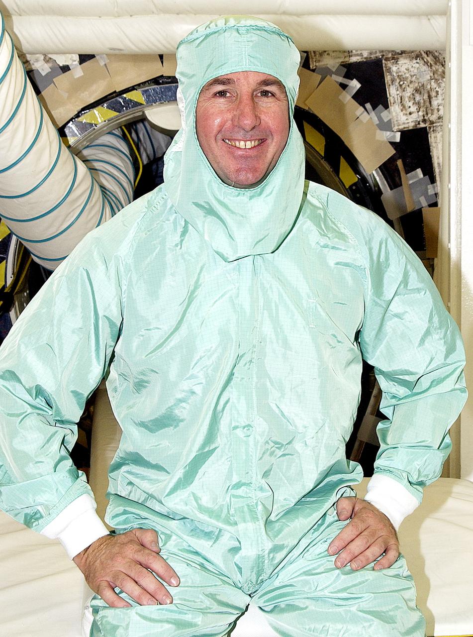 KENNEDY SPACE CENTER, FLA. -  STS-114 Mission Specialist Stephen Robinson sits in the entry hatch to orbiter Atlantis.  He and other crew members - Commander Eileen Collins, Pilot James Kelly and  Mission Specialist Soichi Noguchi - are at KSC for equipment familiarization. Noguchi is with the Japanese space agency NASDA. Mission STS-114 will carry the MultiPurpose Logistics Module (MPLM) Raffaello and External Stowage Platform 2 to the International Space Station.  The MPLM will contain supplies and equipment.  Another goal of the mission is to remove and replace a Control Moment Gyro.  Launch date for mission STS-114 is under review.