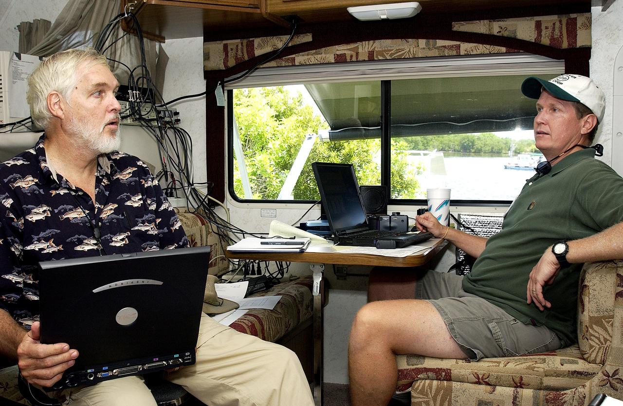 KENNEDY SPACE CENTER, FLA.  -  Dr. Grant Gilmore (left), Dynamac Corp., talks to another member of the research team conducting underwater acoustic research in the Launch Complex 39 turn basin.  Several government agencies, including NASA, NOAA, the Navy, the Coast Guard, and the Florida Fish and Wildlife Commission are involved in the testing. The research involves demonstrations of passive and active sensor technologies, with applications in fields ranging from marine biological research to homeland security. The work is also serving as a pilot project to assess the cooperation between the agencies involved. Equipment under development includes a passive acoustic monitor developed by NASA’s Jet Propulsion Laboratory, and mobile robotic sensors from the Navy’s Mobile Diving and Salvage Unit.