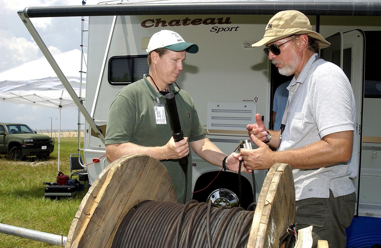 KENNEDY SPACE CENTER, FLA.  -  Research team members work with acoustic cable during underwater acoustic research being conducted in the Launch Complex 39 turn basin.  Several government agencies, including NASA, NOAA, the Navy, the Coast Guard, and the Florida Fish and Wildlife Commission are involved in the testing. The research involves demonstrations of passive and active sensor technologies, with applications in fields ranging from marine biological research to homeland security. The work is also serving as a pilot project to assess the cooperation between the agencies involved. Equipment under development includes a passive acoustic monitor developed by NASA’s Jet Propulsion Laboratory, and mobile robotic sensors from the Navy’s Mobile Diving and Salvage Unit.