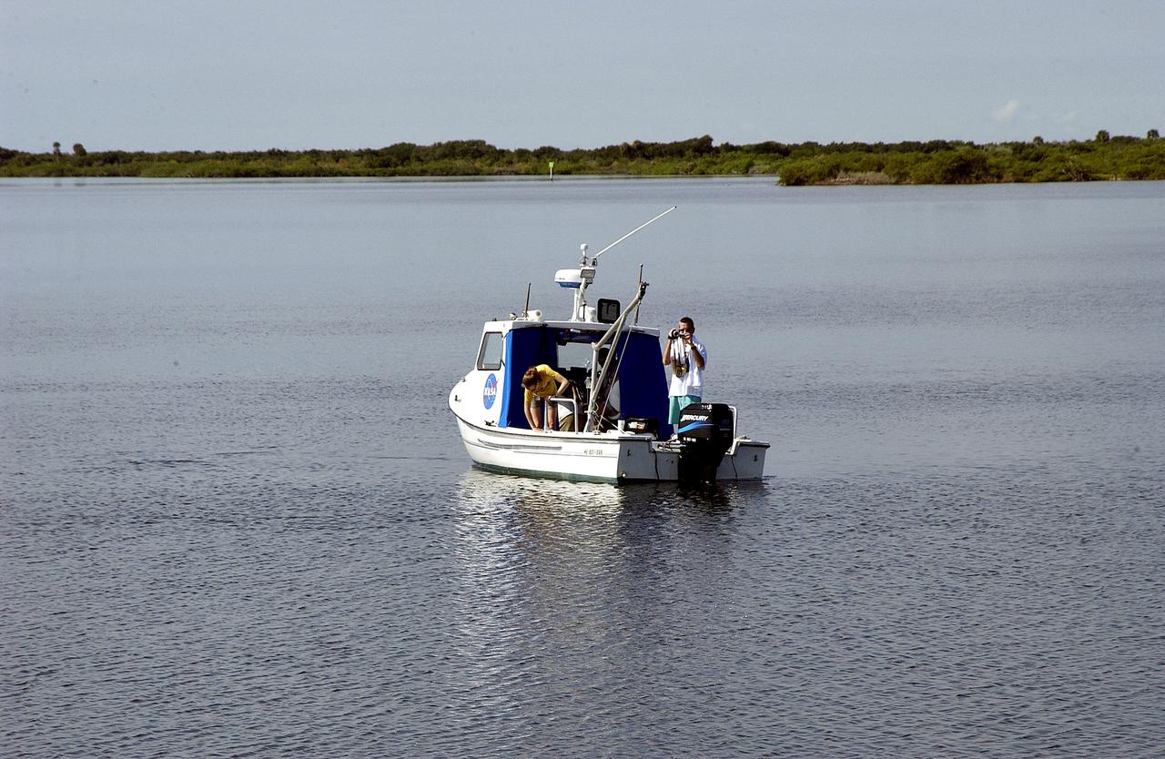 KENNEDY SPACE CENTER, FLA.  -  Researchers are positioned on one of the watercraft being utilized to conduct underwater acoustic research in the Launch Complex 39 turn basin.  Several government agencies, including NASA, NOAA, the Navy, the Coast Guard, and the Florida Fish and Wildlife Commission are involved in the testing. The research involves demonstrations of passive and active sensor technologies, with applications in fields ranging from marine biological research to homeland security. The work is also serving as a pilot project to assess the cooperation between the agencies involved. Equipment under development includes a passive acoustic monitor developed by NASA’s Jet Propulsion Laboratory, and mobile robotic sensors from the Navy’s Mobile Diving and Salvage Unit.