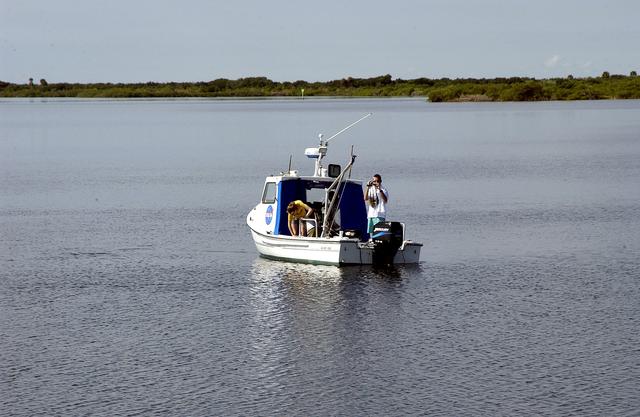 NASA image: KENNEDY SPACE CENTER, FLA.  -  Researchers are positioned on one of the watercraft being utilized to conduct underwater acoustic research in the Launch Complex 39 turn basin.  Several government agencies, including NASA, NOAA, the Navy, the Coast Guard, and the Florida Fish and Wildlife Commission are involved in the testing. The research involves demonstrations of passive and active sensor technologies, with applications in fields ranging from marine biological research to homeland security. The work is also serving as a pilot project to assess the cooperation between the agencies involved. Equipment under development includes a passive acoustic monitor developed by NASA’s Jet Propulsion Laboratory, and mobile robotic sensors from the Navy’s Mobile Diving and Salvage Unit.