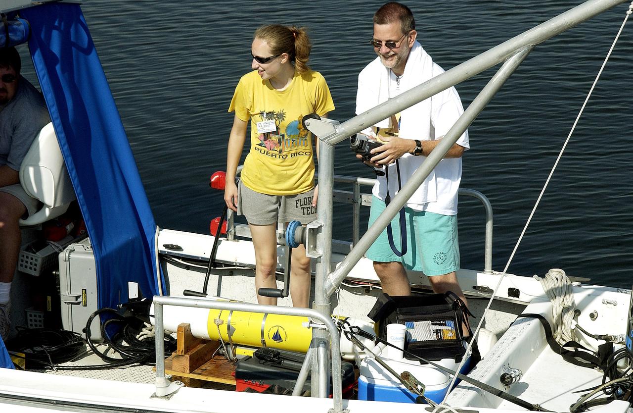 KENNEDY SPACE CENTER, FLA.  -  Research team members take their places on one of the watercraft being utilized to conduct underwater acoustic research in the Launch Complex 39 turn basin.  Several government agencies, including NASA, NOAA, the Navy, the Coast Guard, and the Florida Fish and Wildlife Commission are involved in the testing. The research involves demonstrations of passive and active sensor technologies, with applications in fields ranging from marine biological research to homeland security. The work is also serving as a pilot project to assess the cooperation between the agencies involved. Equipment under development includes a passive acoustic monitor developed by NASA’s Jet Propulsion Laboratory, and mobile robotic sensors from the Navy’s Mobile Diving and Salvage Unit.