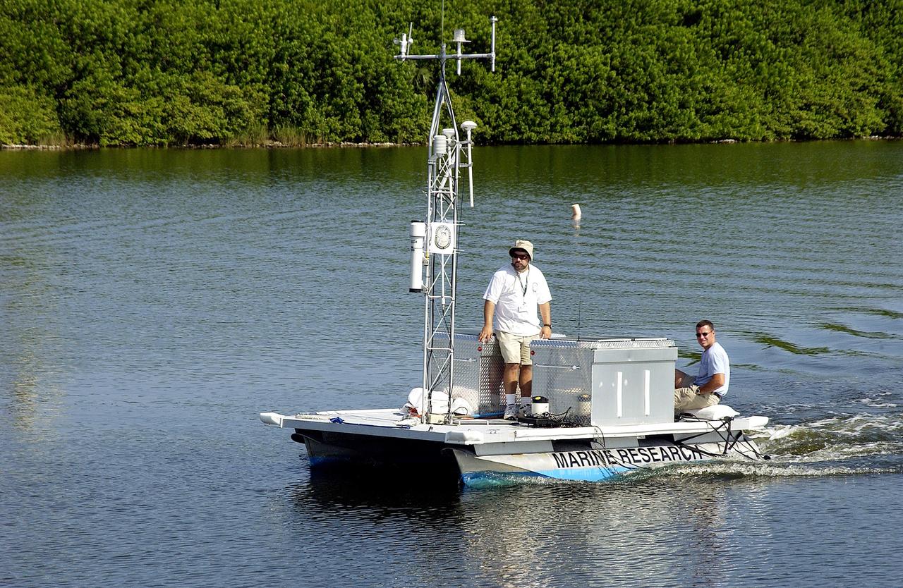 KENNEDY SPACE CENTER, FLA.  -  Researchers are positioned on one of the watercraft being utilized to conduct underwater acoustic research in the Launch Complex 39 turn basin.  Several government agencies, including NASA, NOAA, the Navy, the Coast Guard, and the Florida Fish and Wildlife Commission are involved in the testing. The research involves demonstrations of passive and active sensor technologies, with applications in fields ranging from marine biological research to homeland security. The work is also serving as a pilot project to assess the cooperation between the agencies involved. Equipment under development includes a passive acoustic monitor developed by NASA’s Jet Propulsion Laboratory, and mobile robotic sensors from the Navy’s Mobile Diving and Salvage Unit.