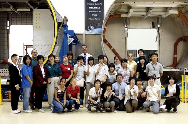 NASA image: KENNEDY SPACE CENTER, FLA.  -   Japanese girls from Urawa Daiichi Girls High School, Urawa, Japan, pose for a group photo on their visit to the Spacehab facility in Cape Canaveral, Fla.  They were awarded the trip when their experiments were chosen to fly on mission STS-107.  The group was also meeting with American students from Melbourne and Jacksonville, Fla.  The girls planned a floral tribute at the STS-107 memorial stone at the facility.  The National Space Development  Agency of Japan (NASDA) and the KSC International Space Station and Payloads Processing Directorate worked with the NASA KSC Education Programs and University Research Division to coordinate the students’ visit.