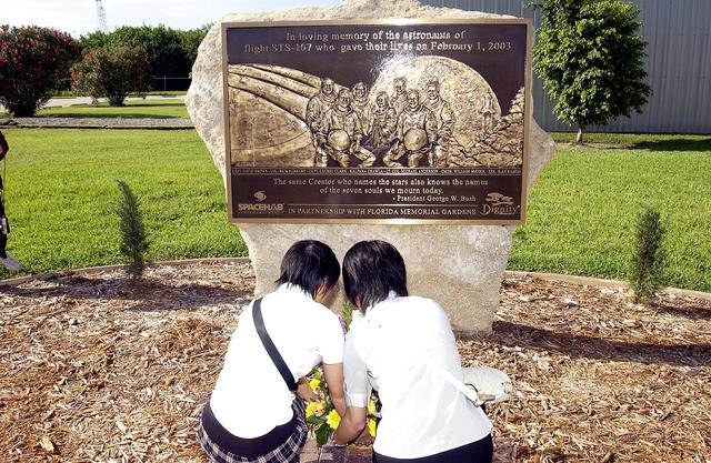 NASA image: KENNEDY SPACE CENTER, FLA.  -   Japanese girls from Urawa Daiichi Girls High School, Urawa, Japan, place a floral tribute to the crew of Columbia at the STS-107 memorial stone at the Spacehab facility, Cape Canaveral, Fla.   The group was  awarded the trip to Florida when their experiments were chosen to fly on mission STS-107.  The group was also meeting with American students from Melbourne and Jacksonville, Fla.   The National Space Development  Agency of Japan (NASDA) and the KSC International Space Station and Payloads Processing Directorate worked with the NASA KSC Education Programs and University Research Division to coordinate the students’ visit.