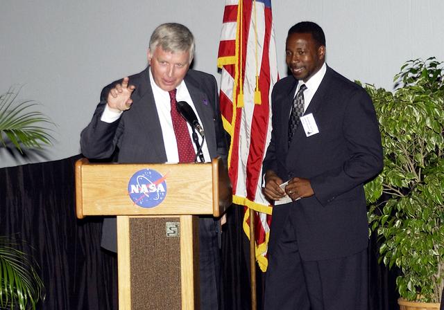 NASA image: KENNEDY SPACE CENTER, FLA.  -  KSC Director Jim Kennedy (left) and incoming KSC Deputy Director Woodrow Whitlow talk about One NASA during the rollout of the Agency initiative at KSC.  They were joined at the IMAX Theater® by other NASA leaders James Jennings,  NASA’s associate deputy administrator for institutions and asset management; Ed Weiler, associate administrator for Space Science; Kevin Peterson, Dryden Flight Research Center director; and implementation team lead Johnny Stevenson to explain how their respective centers contribute to One NASA.  Glenn Research Center Director Dr. Julian Earls gave a motivational speech during the luncheon held at the Visitor Complex Debus Conference Center.