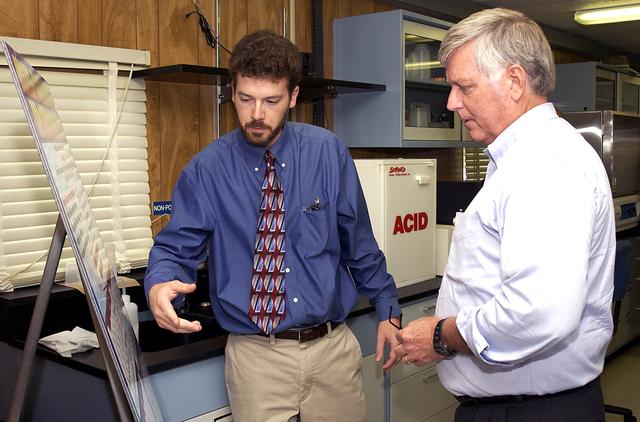 NASA image: KENNEDY SPACE CENTER, FLA. -   Dr. Paul Hintze (left) explains to Center Director Jim Kennedy a project he is working at the KSC Beach Corrosion Test Site. Hitze is doing post-graduate work for the National Research Council.  The test facility site was established in the 1960s and has provided more than 30 years of historical information on the long-term performance of many materials in use at KSC and other locations around the world. Located 100 feet from the Atlantic Ocean approximately 1 mile south of the Space Shuttle launch sites, the test facility includes an atmospheric exposure site, a flowing seawater exposure site, and an on-site electrochemistry laboratory and monitoring station. The beach laboratory is used to conduct real-time corrosion experiments and provides for the remote monitoring of surrounding weather conditions. The newly added flowing seawater immersion facility provides for the immersion testing of materials and devices under controlled conditions.