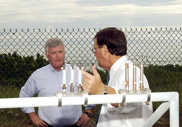 NASA image: KENNEDY SPACE CENTER, FLA. -    Louis MacDowell (right), Testbed manager, explains to Center Director Jim Kennedy the use of astmospheric calibration specimens.  Placed at various locations, they can rank the corrosivity of the given environment.  The KSC Beach Corrosion Test Site was established in the 1960s and has provided more than 30 years of historical information on the long-term performance of many materials in use at KSC and other locations around the world. Located 100 feet from the Atlantic Ocean approximately 1 mile south of the Space Shuttle launch sites, the test facility includes an atmospheric exposure site, a flowing seawater exposure site, and an on-site electrochemistry laboratory and monitoring station. The beach laboratory is used to conduct real-time corrosion experiments and provides for the remote monitoring of surrounding weather conditions. The newly added flowing seawater immersion facility provides for the immersion testing of materials and devices under controlled conditions.