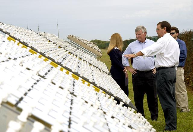 NASA image: KENNEDY SPACE CENTER, FLA. -   On a tour of the KSC Beach Corrosion Test Site, Testbed Manager Louis MacDowell (foreground) explains to Center Director Jim Kennedy (third from right) about a study being undertaken for the U.S. Navy: nonchrome primers for aircraft. At left is Lead Scientist Dr. Luz Marina Calle and behind MacDowell is Dr. Paul Hintze, who is working on a graduate project for the National Research Council.  The KSC Beach Corrosion Test Site was established in the 1960s and has provided more than 30 years of historical information on the long-term performance of many materials in use at KSC and other locations around the world. Located 100 feet from the Atlantic Ocean approximately 1 mile south of the Space Shuttle launch sites, the test facility includes an atmospheric exposure site, a flowing seawater exposure site, and an on-site electrochemistry laboratory and monitoring station. The beach laboratory is used to conduct real-time corrosion experiments and provides for the remote monitoring of surrounding weather conditions. The newly added flowing seawater immersion facility provides for the immersion testing of materials and devices under controlled conditions.