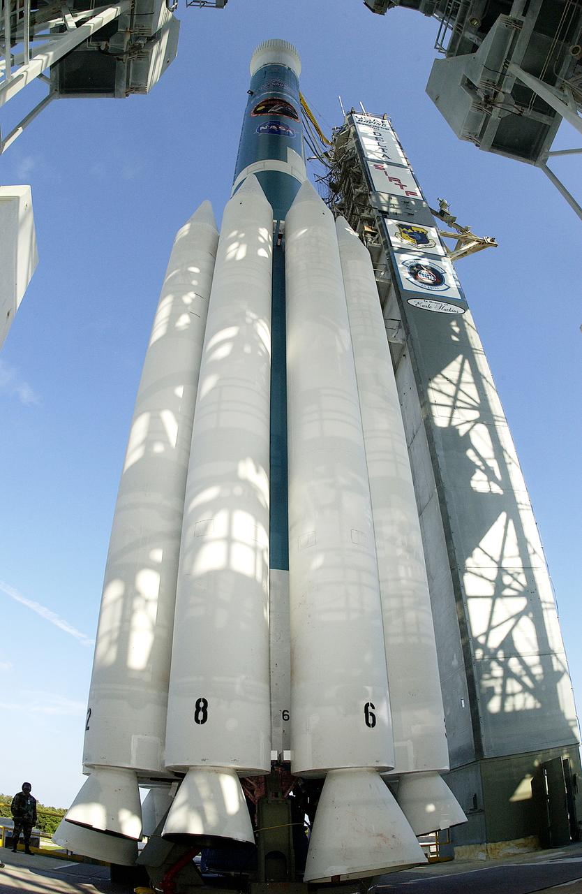 The mobile service tower is rolled back at Launch Pad 17-B, Cape Canaveral Air Force Station, to reveal NASA's Space Infrared Telescope Facility (SIRTF) ready for launch aboard a Delta II Heavy launch vehicle. Liftoff is scheduled for Aug. 25 at 1:35:39 a.m. EDT. SIRTF will obtain images and spectra by detecting the infrared energy, or heat, radiated by objects in space. Consisting of a 0.85-meter telescope and three cryogenically cooled science instruments, SIRTF will be the largest infrared telescope ever launched into space. It is the fourth and final element in NASA’s family of orbiting “Great Observatories.” Its highly sensitive instruments will give a unique view of the Universe and peer into regions of space that are hidden from optical telescopes.