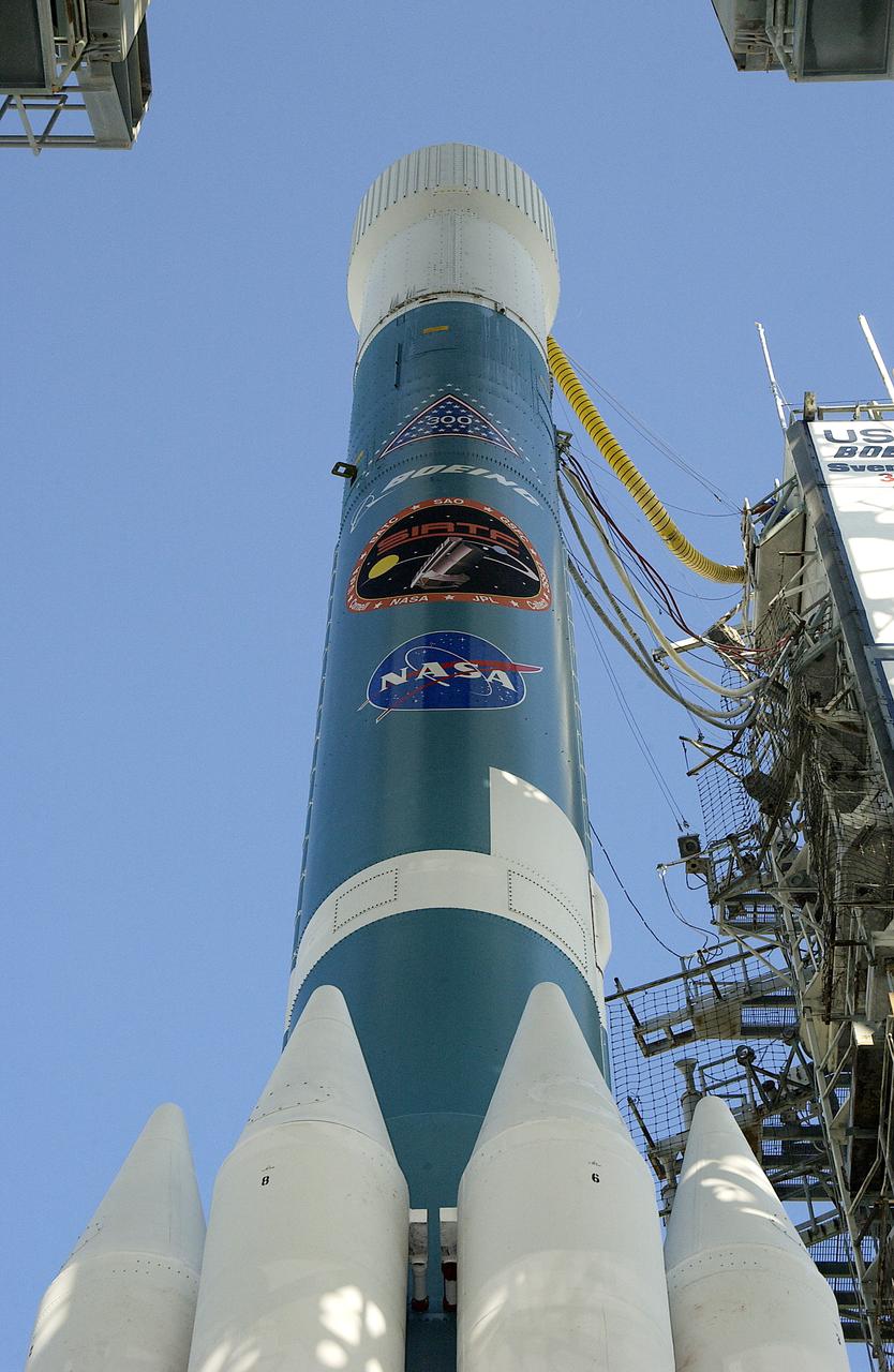 The mobile service tower is rolled back at Launch Pad 17-B, Cape Canaveral Air Force Station, to reveal NASA's Space Infrared Telescope Facility (SIRTF) ready for launch aboard a Delta II Heavy launch vehicle. Liftoff is scheduled for Aug. 25 at 1:35:39 a.m. EDT. SIRTF will obtain images and spectra by detecting the infrared energy, or heat, radiated by objects in space. Consisting of a 0.85-meter telescope and three cryogenically cooled science instruments, SIRTF will be the largest infrared telescope ever launched into space. It is the fourth and final element in NASA’s family of orbiting “Great Observatories.” Its highly sensitive instruments will give a unique view of the Universe and peer into regions of space that are hidden from optical telescopes.