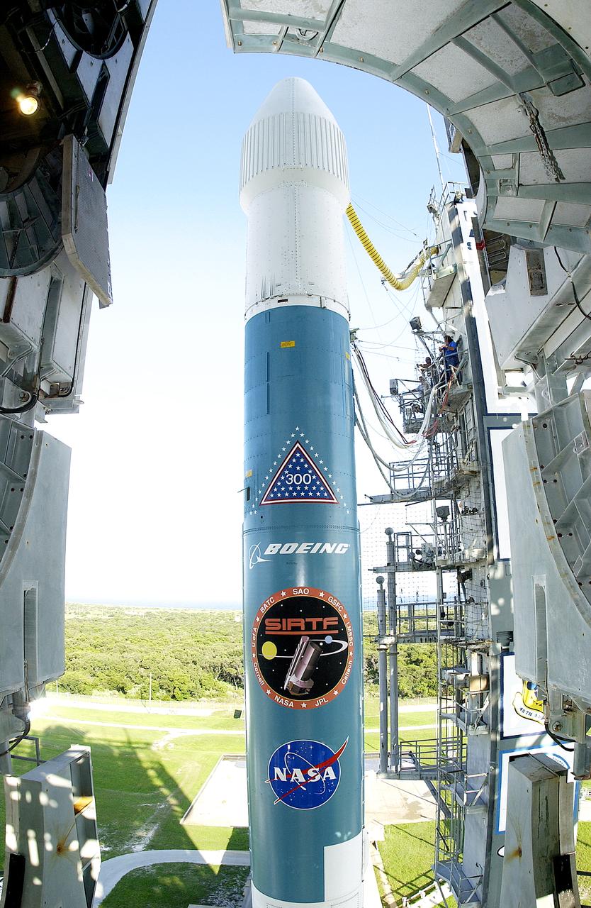 The mobile service tower is rolled back at Launch Pad 17-B, Cape Canaveral Air Force Station, to reveal NASA's Space Infrared Telescope Facility (SIRTF) ready for launch aboard a Delta II Heavy launch vehicle. Liftoff is scheduled for Aug. 25 at 1:35:39 a.m. EDT. SIRTF will obtain images and spectra by detecting the infrared energy, or heat, radiated by objects in space. Consisting of a 0.85-meter telescope and three cryogenically cooled science instruments, SIRTF will be the largest infrared telescope ever launched into space. It is the fourth and final element in NASA’s family of orbiting “Great Observatories.” Its highly sensitive instruments will give a unique view of the Universe and peer into regions of space that are hidden from optical telescopes.