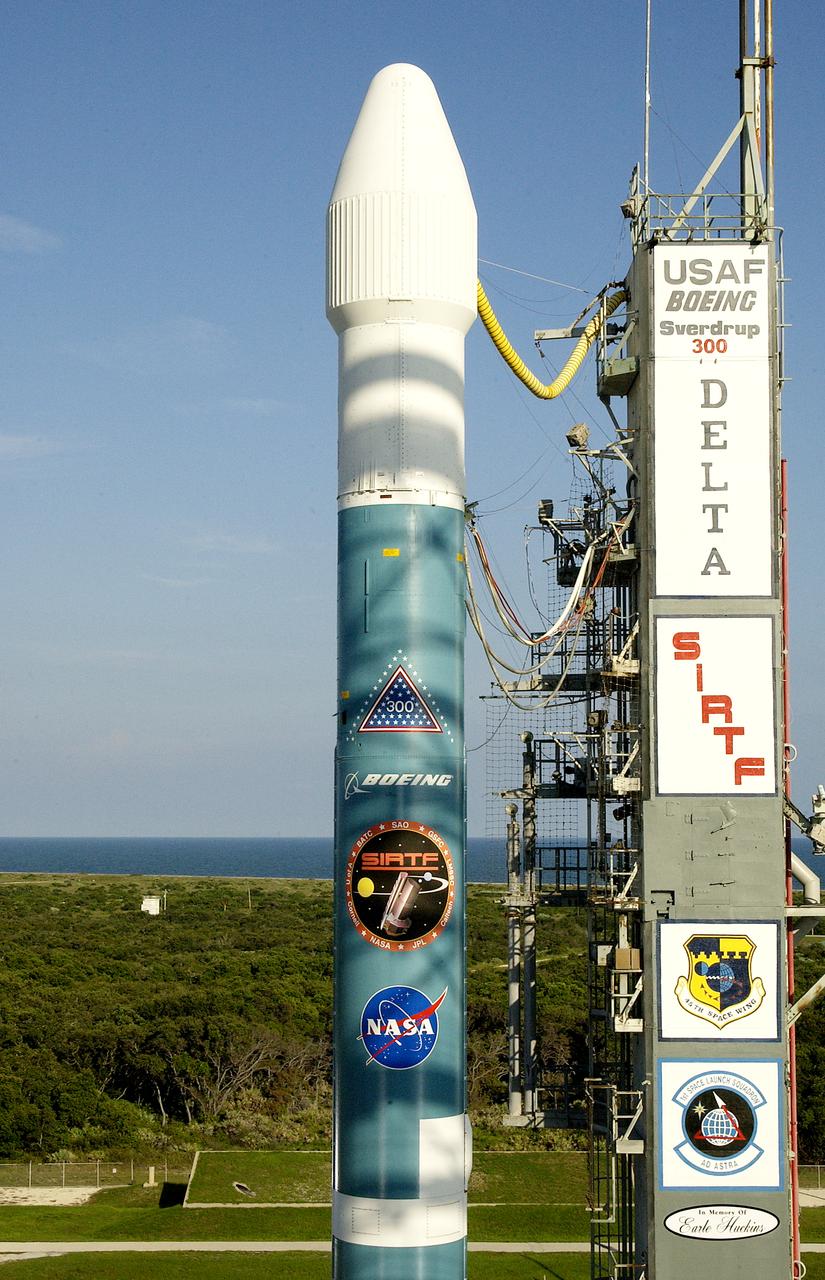 The mobile service tower is rolled back at Launch Pad 17-B, Cape Canaveral Air Force Station, to reveal NASA's Space Infrared Telescope Facility (SIRTF) ready for launch aboard a Delta II Heavy launch vehicle. Liftoff is scheduled for Aug. 25 at 1:35:39 a.m. EDT. SIRTF will obtain images and spectra by detecting the infrared energy, or heat, radiated by objects in space. Consisting of a 0.85-meter telescope and three cryogenically cooled science instruments, SIRTF will be the largest infrared telescope ever launched into space. It is the fourth and final element in NASA’s family of orbiting “Great Observatories.” Its highly sensitive instruments will give a unique view of the Universe and peer into regions of space that are hidden from optical telescopes.