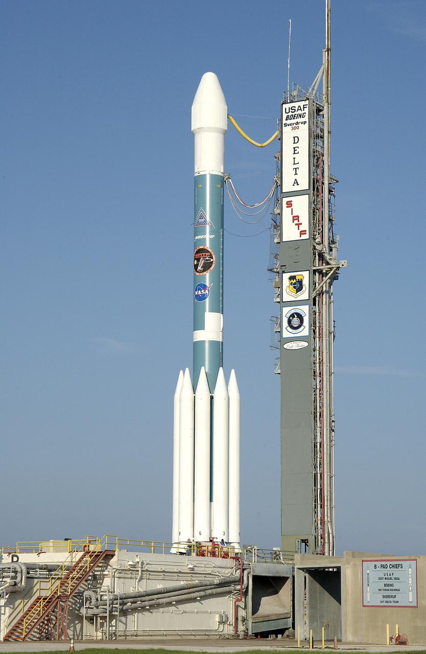 The mobile service tower is rolled back at Launch Pad 17-B, Cape Canaveral Air Force Station, to reveal NASA's Space Infrared Telescope Facility (SIRTF) ready for launch aboard a Delta II Heavy launch vehicle. Liftoff is scheduled for Aug. 25 at 1:35:39 a.m. EDT. SIRTF will obtain images and spectra by detecting the infrared energy, or heat, radiated by objects in space. Consisting of a 0.85-meter telescope and three cryogenically cooled science instruments, SIRTF will be the largest infrared telescope ever launched into space. It is the fourth and final element in NASA’s family of orbiting “Great Observatories.” Its highly sensitive instruments will give a unique view of the Universe and peer into regions of space that are hidden from optical telescopes.
