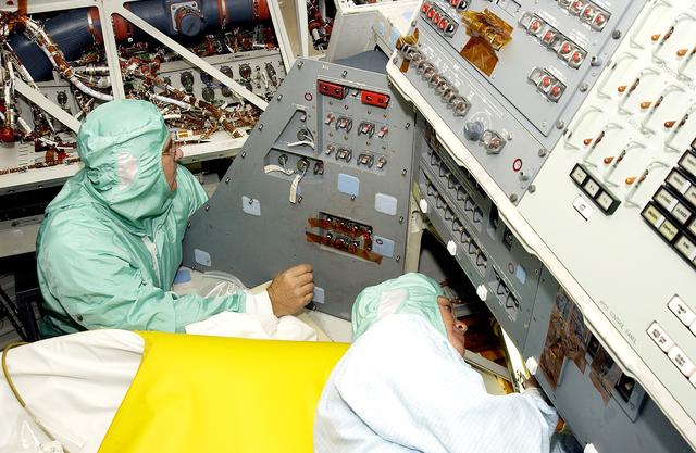 NASA image: KENNEDY SPACE CENTER, FLA.  -     Technicians with United Space Alliance work in close quarters as they check the wiring on the mid-body of orbiter Atlantis.  The inspection is part of routine maintenance.