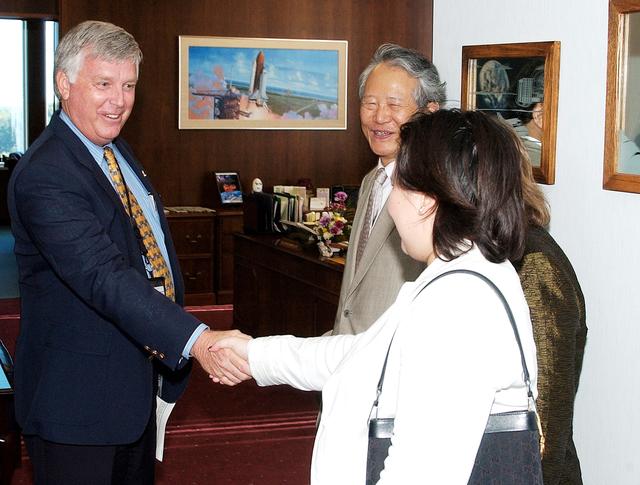 NASA image: KENNEDY SPACE CENTER, FLA. - KSC Director James W. Kennedy receives Consul General of Japan Ko Kodaira and his family in his office in Headquarters Building during their visit to Kennedy Space Center (KSC).  From left are Kennedy, Kodaira, his wife Marie (partially hidden), and his daughter Reiko. Kodaira is touring the facilities at KSC at the invitation of the local office of the National Space Development Agency of Japan (NASDA) to acquaint him with KSC's unique processing capabilities.