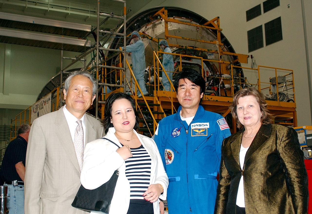 KENNEDY SPACE CENTER, FLA. - From left, the Consul General of Japan Ko Kodaira, his daughter Reiko, astronaut Dr. Takao Doi, and Kodaira's wife Marie pause for a photograph in the Space Station Processing Facility during their visit to Kennedy Space Center (KSC). Doi represented Japan on Space Shuttle mission STS-87, the fourth U.S Microgravity Payload flight.  Kodaira is touring the facilities at KSC at the invitation of the local office of the National Space Development Agency of Japan (NASDA) to acquaint him with KSC's unique processing capabilities.
