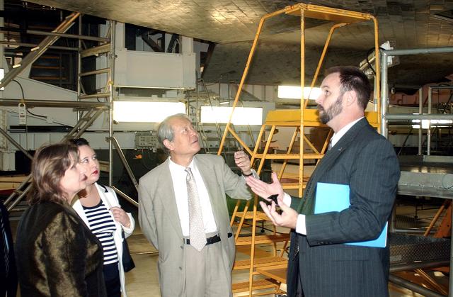 NASA image: KENNEDY SPACE CENTER, FLA. - NASA Manager Steve Cain explains aspects of Space Shuttle processing to Consul General of Japan Ko Kodaira and his family in the Orbiter Processing Facility during their visit to Kennedy Space Center (KSC). From left are Kodaira's wife Marie, his daughter Reiko, Kodaira, and Cain, Senior Future International Space Station Element Manager. Kodaira is touring the facilities at KSC at the invitation of the local office of the National Space Development Agency of Japan (NASDA) to acquaint him with KSC's unique processing capabilities.