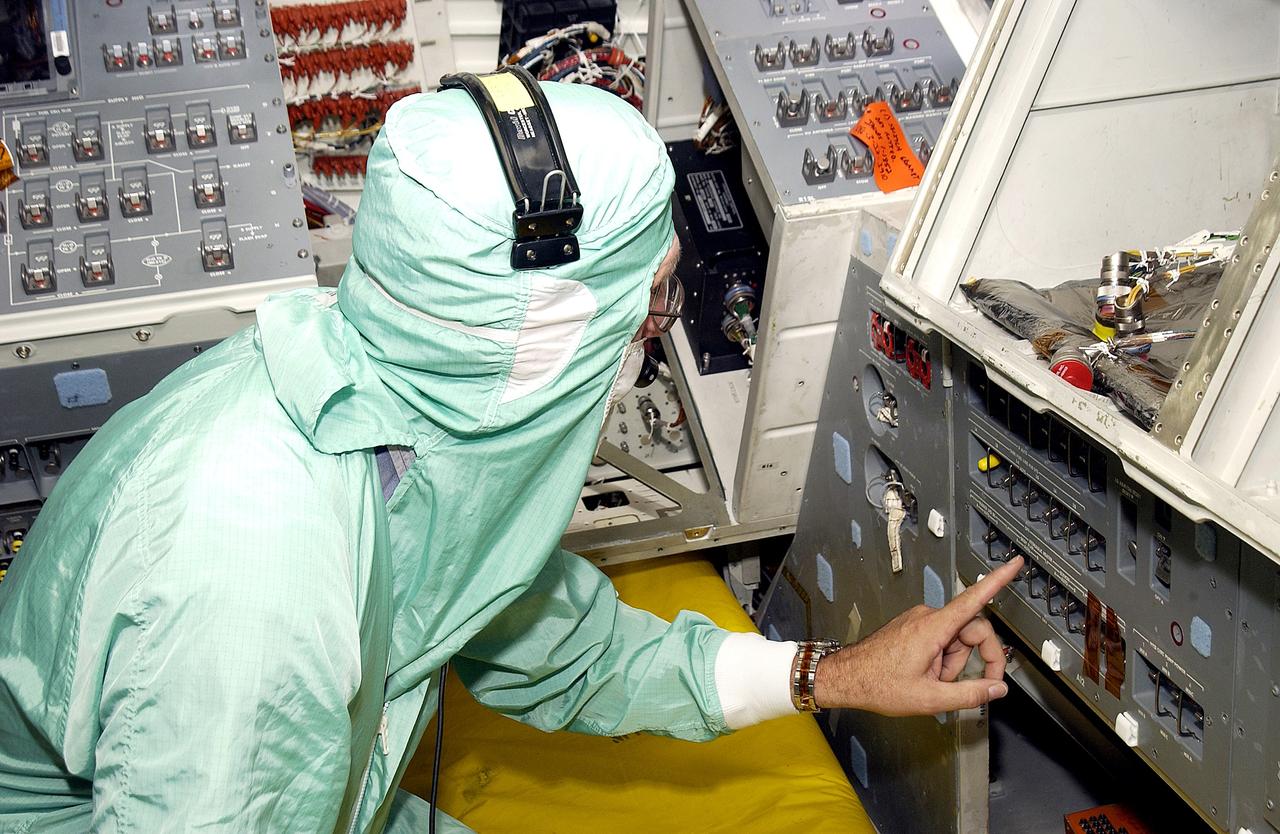 KENNEDY SPACE CENTER, FLA.  -  During power-up of the orbiter Discovery in the Orbiter Processing Facility, a technician moves a switch.  Discovery has been undergoing Orbiter Major Modifications in the past year, ranging from wiring, control panels and black boxes to gaseous and fluid systems tubing and components.  These systems were deserviced, disassembled, inspected, modified, reassembled, checked out and reserviced, as were most other systems onboard.  The work includes the installation of the Multifunction Electronic Display Subsystem (MEDS) - a state-of-the-art “glass cockpit.”