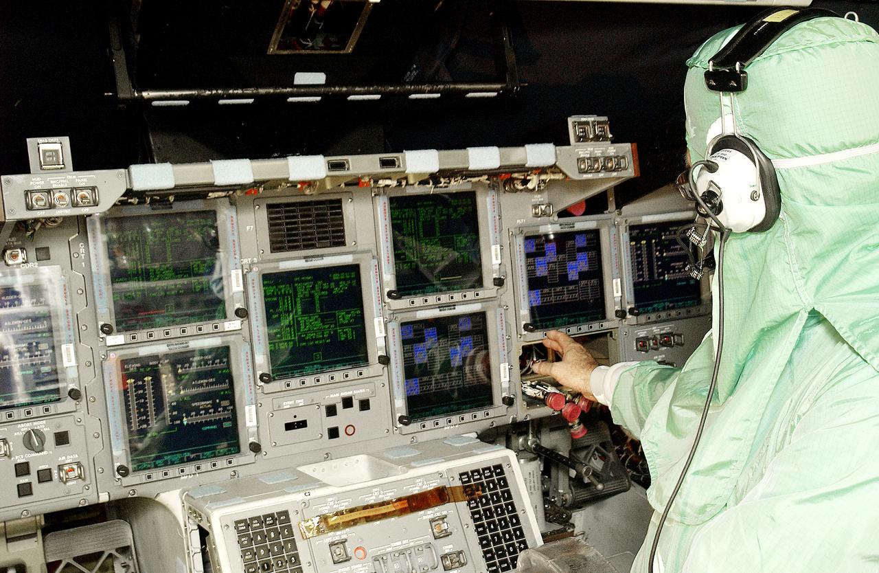 During power-up of the orbiter Discovery in the Orbiter Processing Facility, a technician adjusts a monitor on the console. Discovery has been undergoing Orbiter Major Modifications in the past year, ranging from wiring, control panels and black boxes to gaseous and fluid systems tubing and components. These systems were deserviced, disassembled, inspected, modified, reassembled, checked out and reserviced, as were most other systems onboard. The work includes the installation of the Multifunction Electronic Display Subsystem (MEDS) - a state-of-the-art “glass cockpit.”