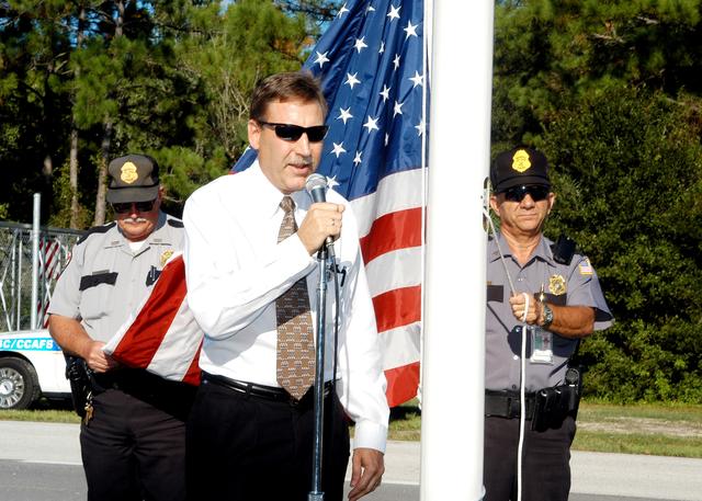 NASA image: KENNEDY SPACE CENTER, FLA.  -  Daniel L. Tweed, with the Facilities Division, NASA Spaceport Services, addresses attendees at the ribbon cutting for the KSC Security gates.  Tweed was project manager.  The two new Security gates on Kennedy Parkway (Gate 2) and NASA Parkway (Gate 3) were activated Aug. 1, allowing the general public to have access to the new Space Commerce Way, which will provide access to the Research Park and KSC Visitor Complex, and providing an alternate route for the general public between Titusville and Merritt Island that is accessible 24 hours a day.  The gates are staffed 24 hours daily.  Others taking part in the ribbon cutting were Center Director Jim Kennedy; Chief, Protective & Safe Guards Office, Calvin L. Burch; SGS Deputy Program Manager William A. Sample; and Bobby Porter, with Oneida Construction.