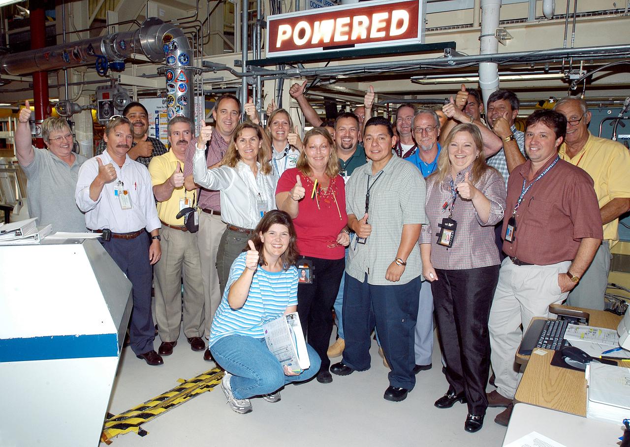 KENNEDY SPACE CENTER, FLA.  -  In the Orbiter Processing Facility, the processing team celebrates the  successful power-up of the orbiter Discovery.  The vehicle has been undergoing Orbiter Major Modifications in the past year, ranging from wiring, control panels and black boxes to gaseous and fluid systems tubing and components.  These systems were deserviced, disassembled, inspected, modified, reassembled, checked out and reserviced, as were most other systems onboard.  The work includes the installation of the Multifunction Electronic Display Subsystem (MEDS) - a state-of-the-art “glass cockpit.”