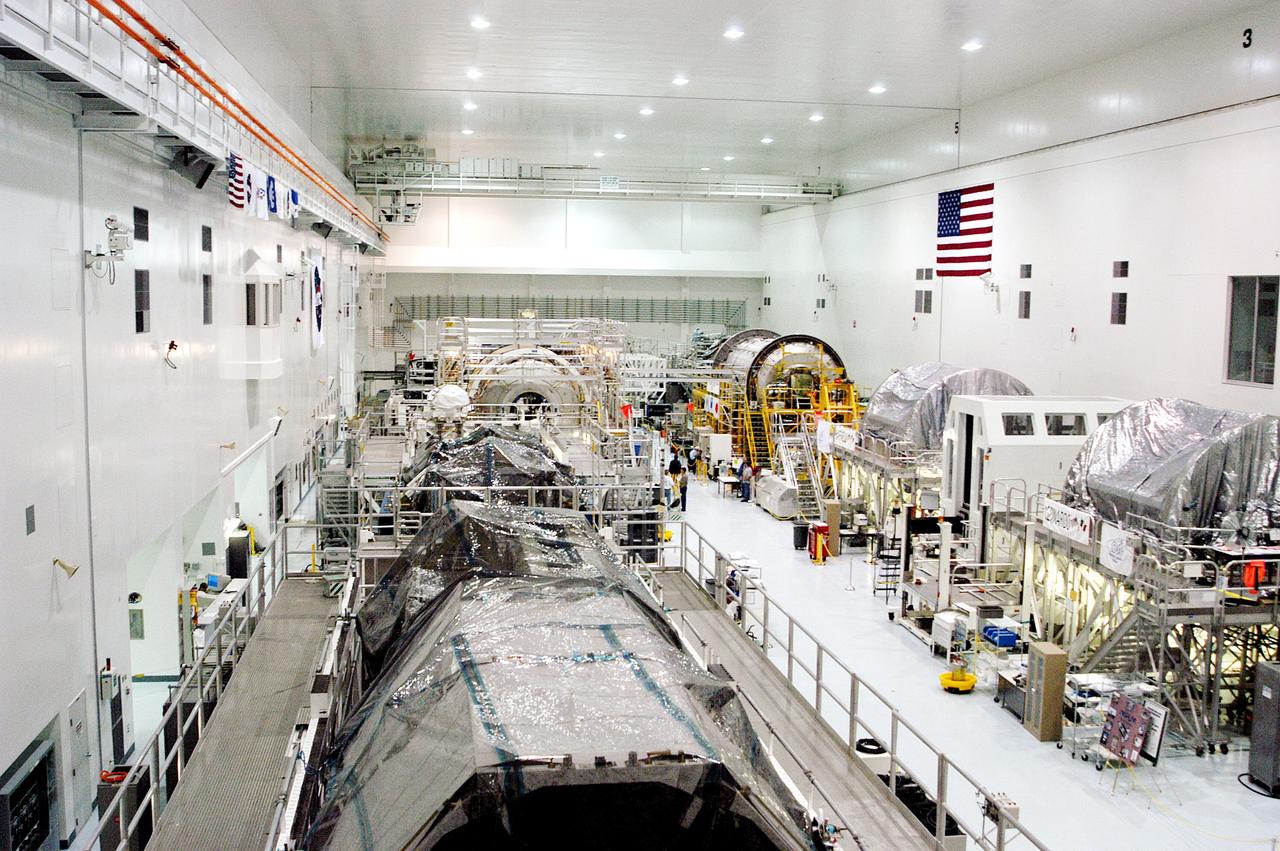KENNEDY SPACE CENTER, FLA. -  Various elements intended for the International Space Station are lined up in the Space Station Processing Facility.  The newest to arrive at KSC are in the rear: at left, the U.S. Node 2, and at right, the Japanese Experiment Module (JEM).  The two elements are undergoing a Multi-Element Integrated Test (MEIT).   Node 2 attaches to the end of the U.S. Lab on the ISS and provides attach locations for the Japanese laboratory, European laboratory, the Centrifuge Accommodation Module and, eventually, Multipurpose Logistics Modules. It will provide the primary docking location for the Shuttle when a pressurized mating adapter is attached to Node 2.  Installation of the module will complete the U.S. Core of the ISS.   Developed by the National Space Development Agency of Japan (NASDA), the JEM is Japan's primary contribution to the Station. It will enhance the unique research capabilities of the orbiting complex by providing an additional environment for astronauts to conduct science experiments.