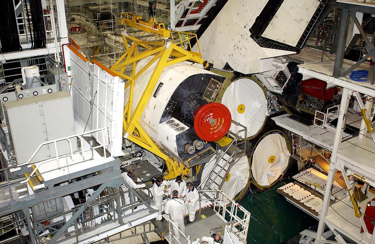 KENNEDY SPACE CENTER, FLA. -  In the Orbiter Processing Facility, technicians prepare to remove an Orbital Maneuvering System (OMS) pod from the orbiter Atlantis during routine maintenance.