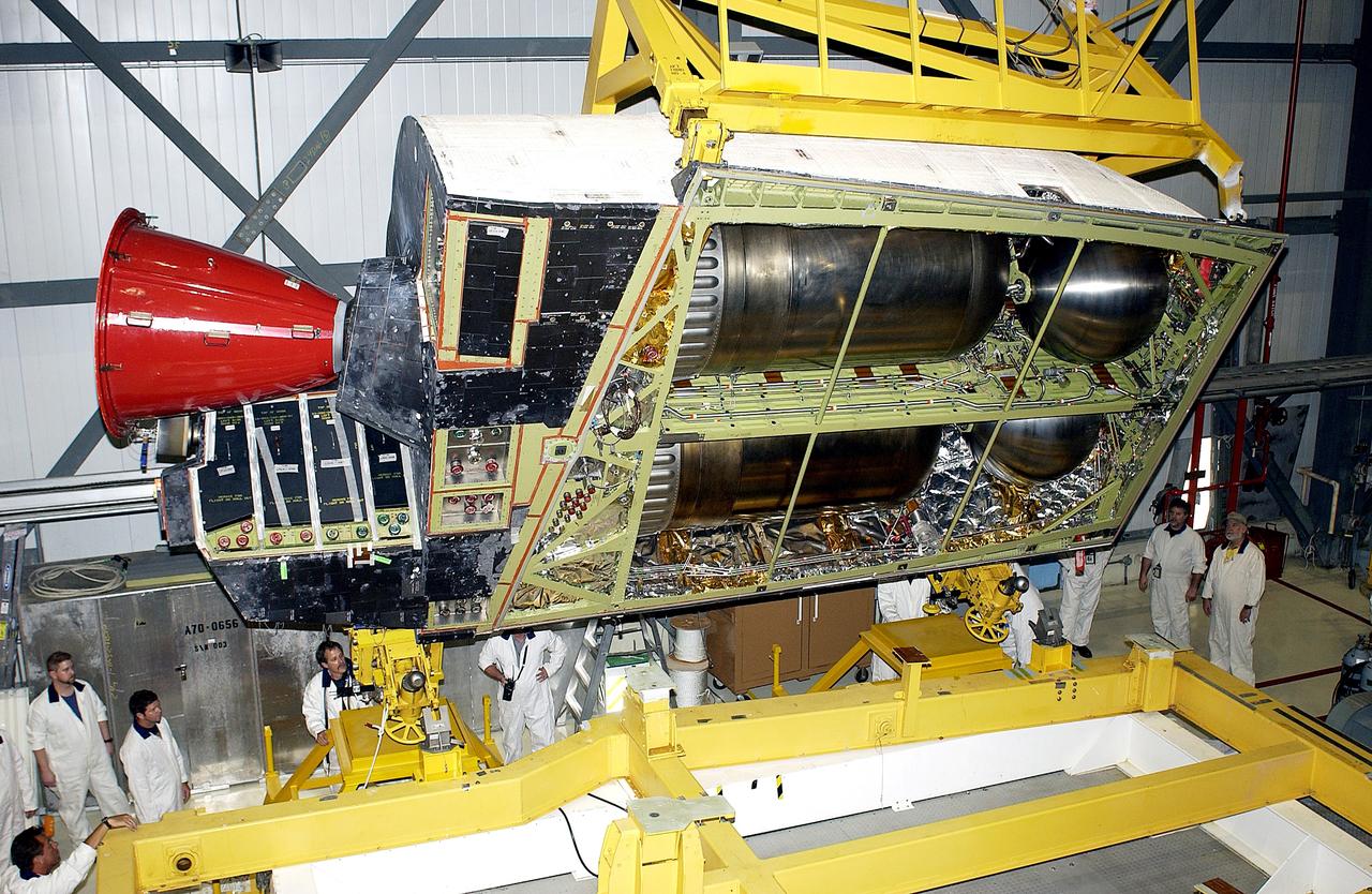 KENNEDY SPACE CENTER, FLA. - In the Orbiter Processing Facility, an Orbital Maneuvering System (OMS) pod is removed from  the orbiter Atlantis during routine maintenance.